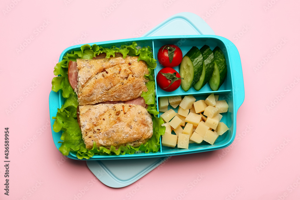 Lunchbox with tasty food on color background