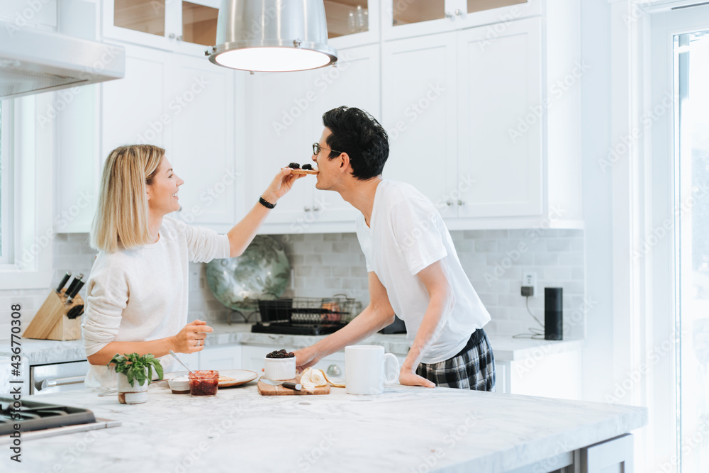 Woman playfully feeding her boyfriend