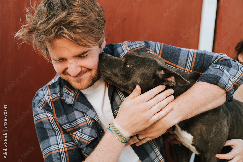 A man with his pit bull terrier dog