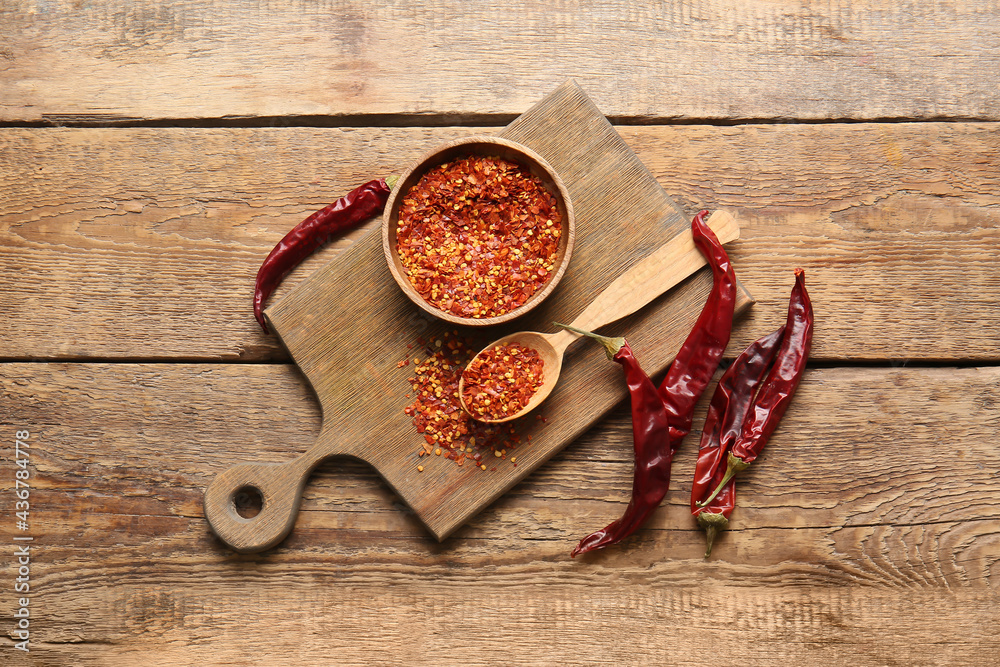 Composition with hot chili pepper on wooden background