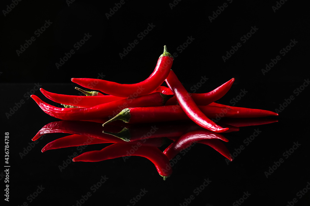 Hot chili peppers on dark background