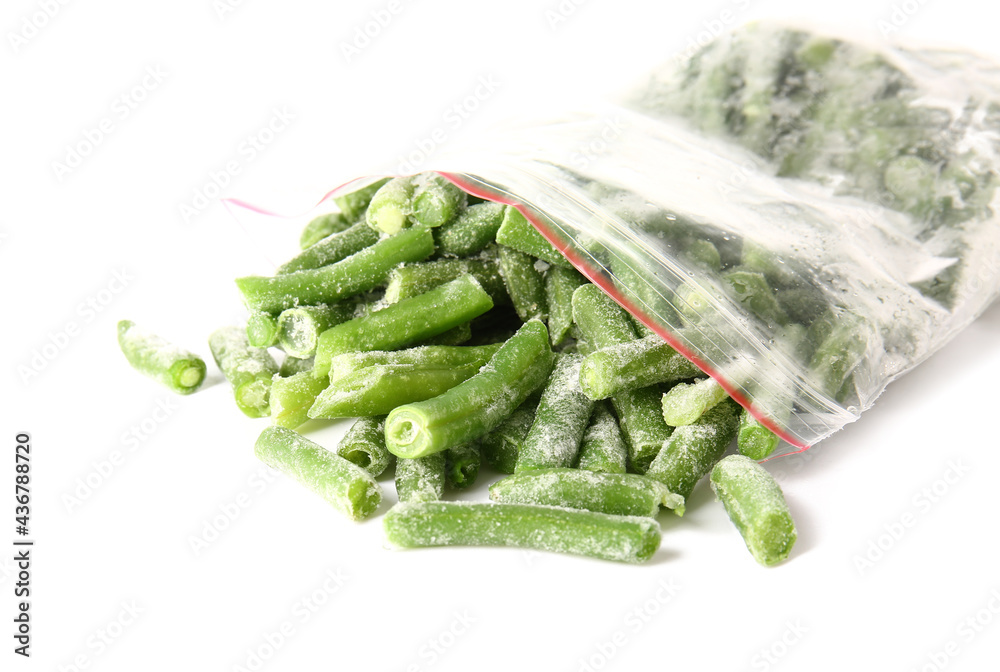 Plastic bag with frozen green beans on white background