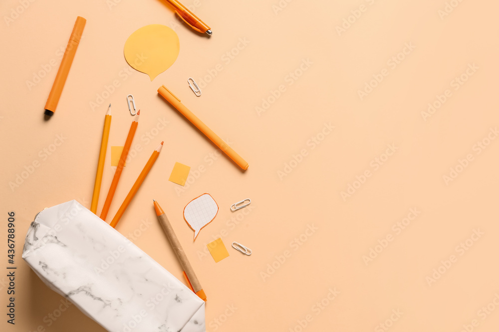 Pencil case and stationery on color background