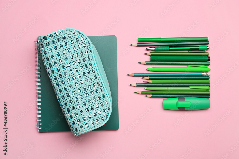 Pencil case and stationery on color background