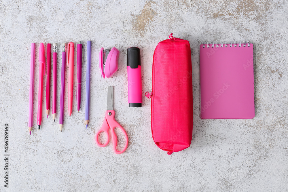 Pencil case with stationery on light background