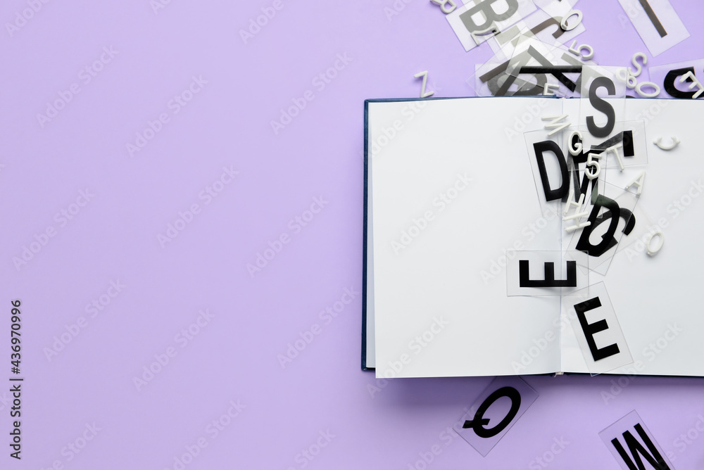 Blank book with letters on color background