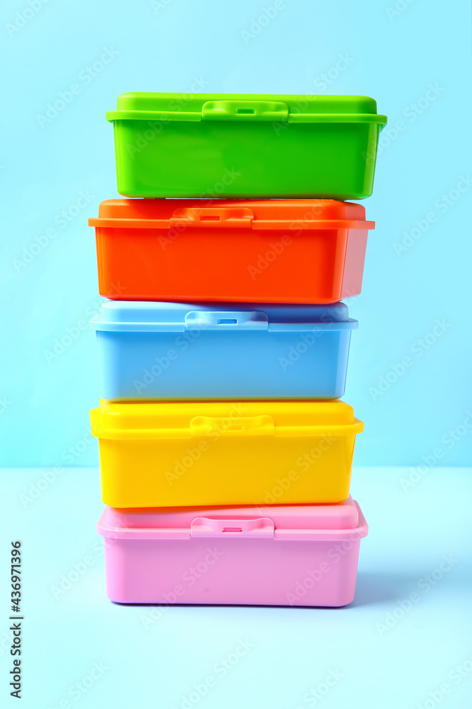 Plastic lunch boxes on color background