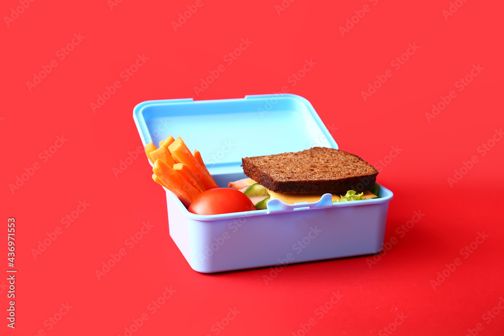 Lunch box with tasty food on color background