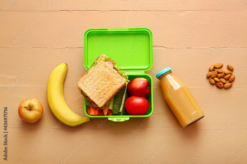 Lunch box with tasty food on color background