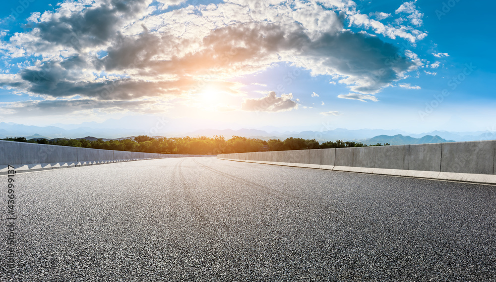 Asphalt highway and mountain landscape at sunset,road pavement background.