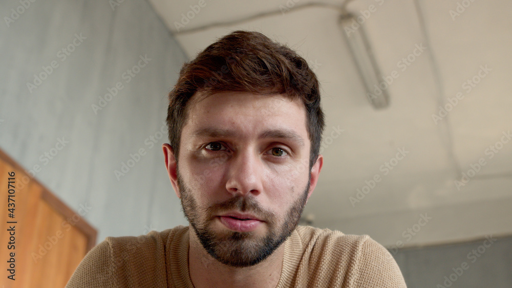 Young man looking at laptop by video link close-up