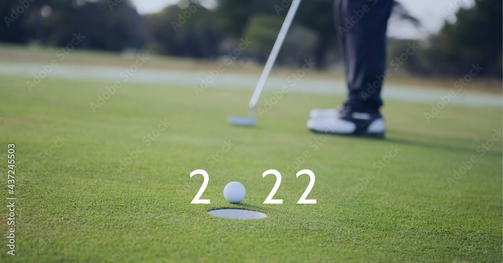 Composition of 2022 number with golf ball by hole on golf course