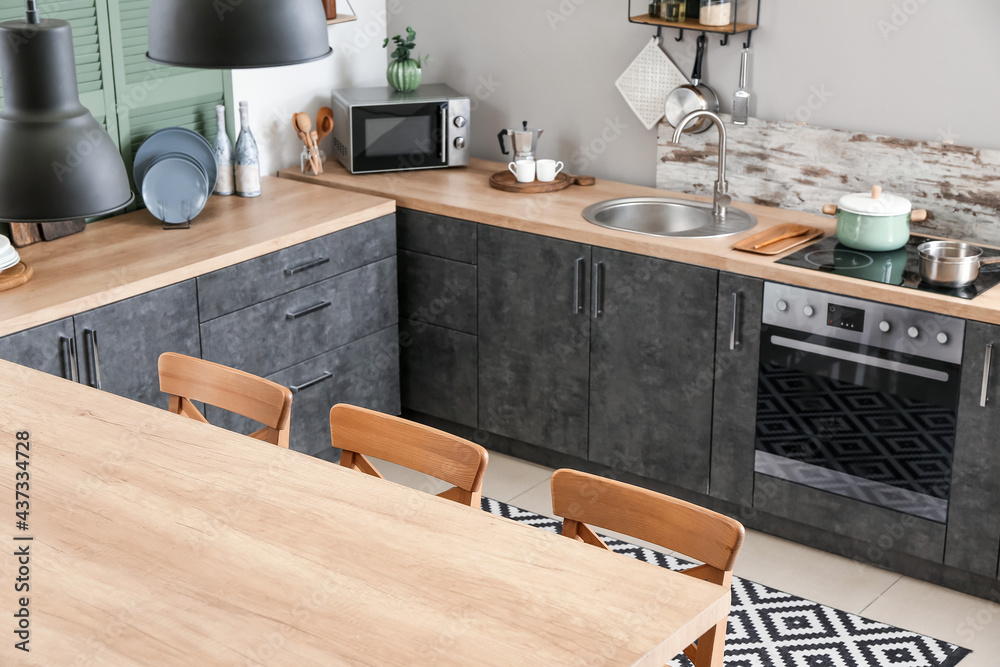 Cooking utensils and products on table in interior of modern kitchen