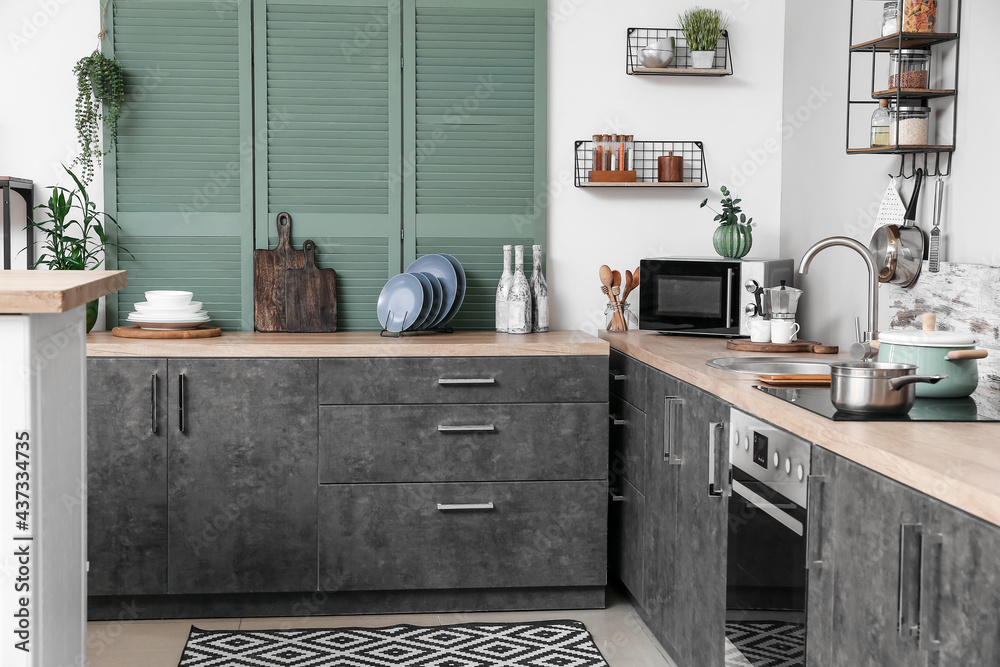 Cooking utensils and products on table in interior of modern kitchen