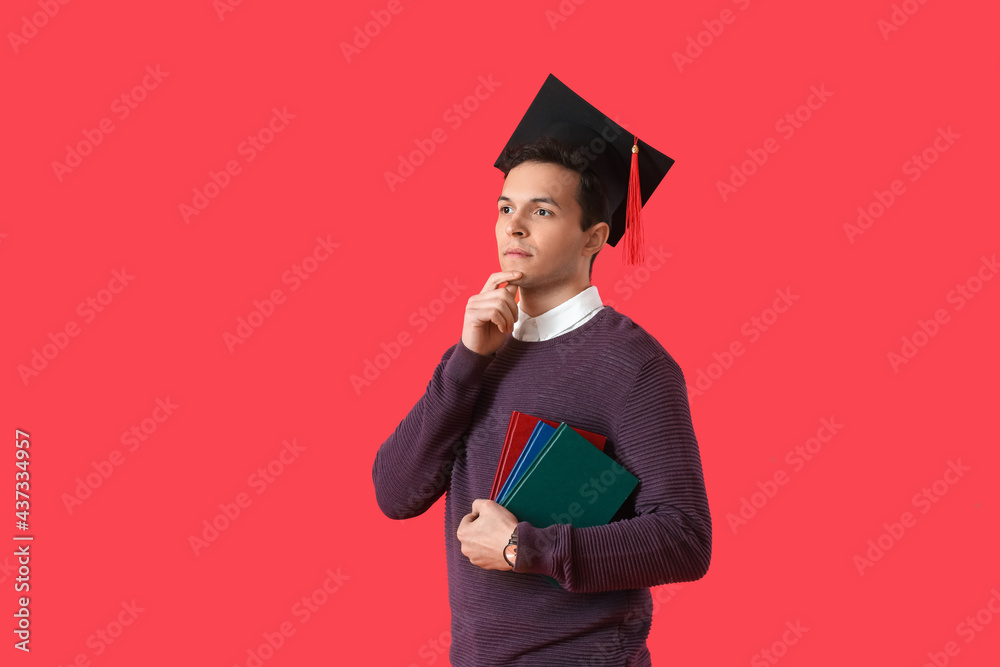 Male graduating student on color background