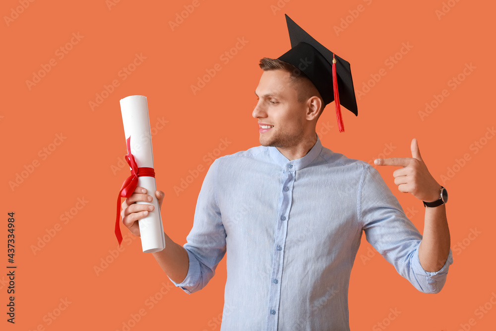 Male graduating student on color background