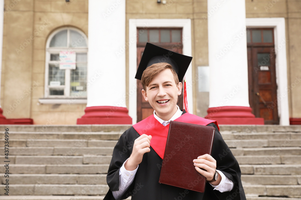 Portrait of male graduating student outdoors