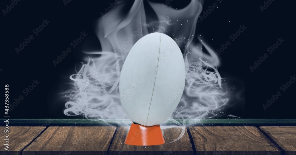 Compostion of white rugby ball on black background with white smoke