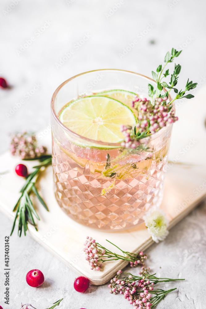 making cocktails in glasses with lime and berries on stone kitchen desk background