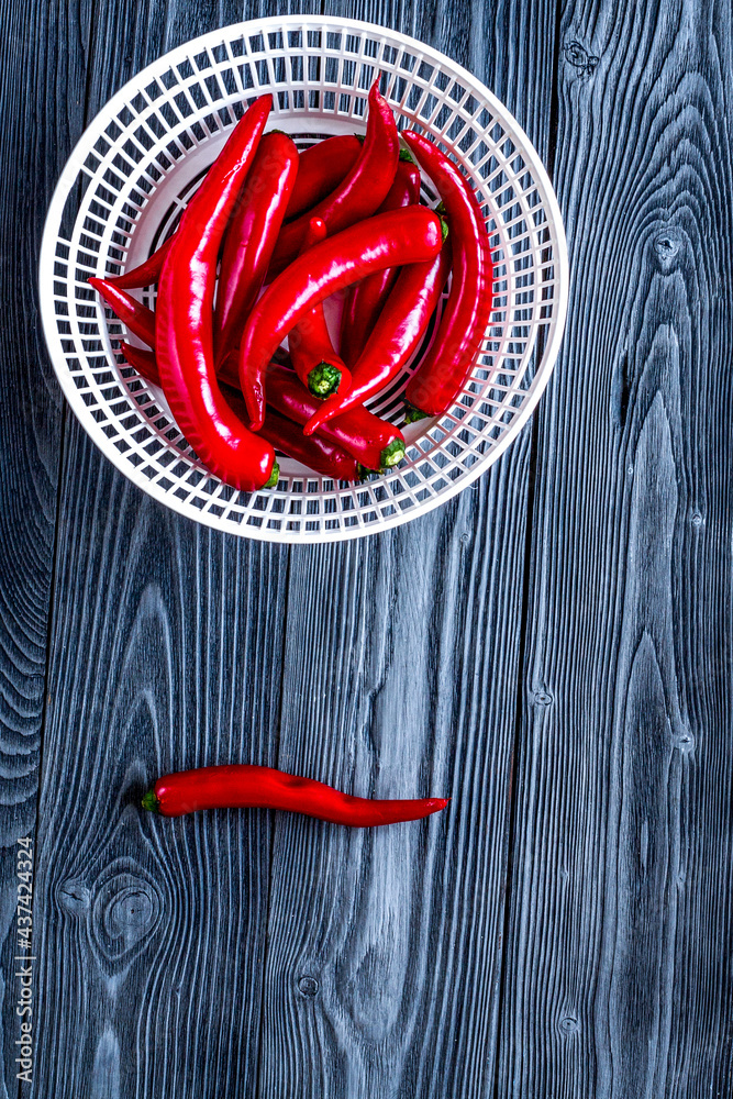 red chili pepper frame design on dark table background top view mock-up