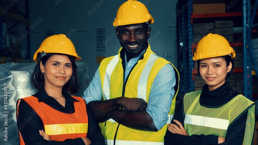 Portrait of happy warehouse worker in the storehouse . Logistics , supply chain and warehouse busine