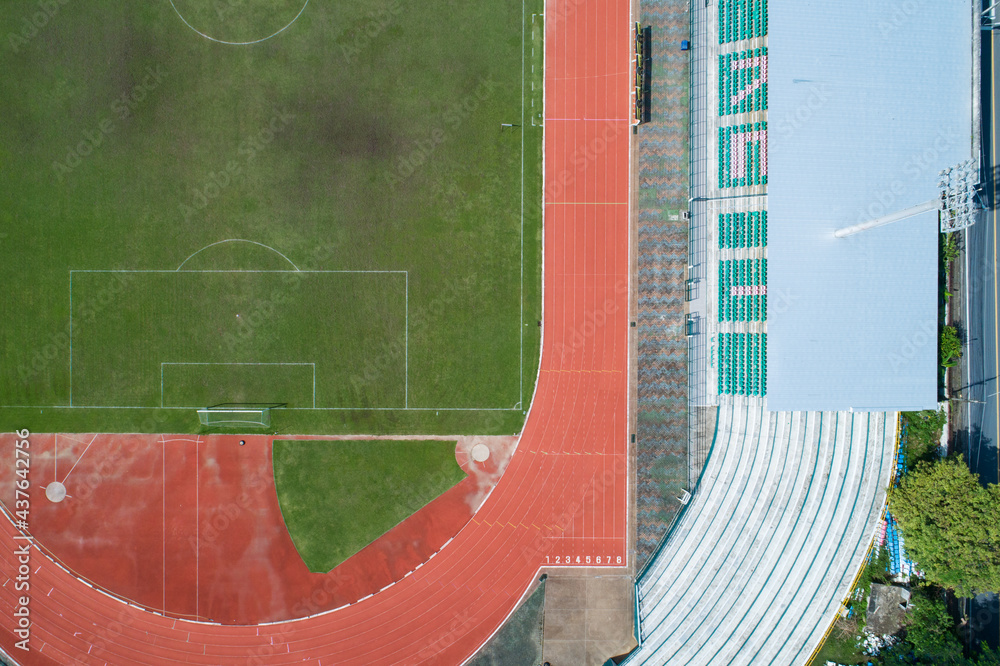 Aerial view of empty green football field with running track Empty stadium view from top.