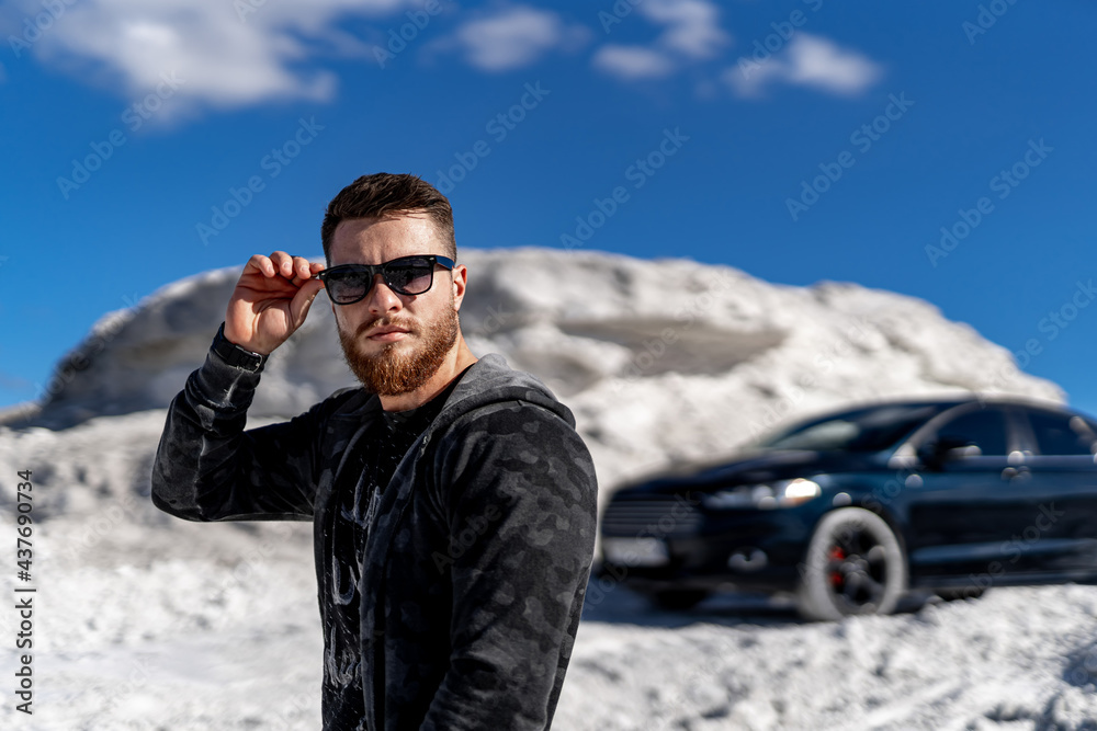 Stylish model posing with car. Young handsome fashionable businessman.