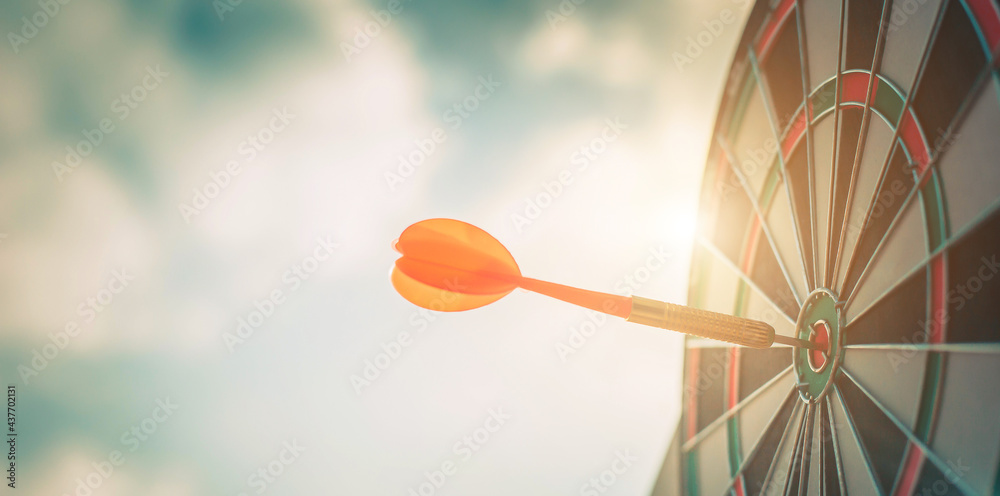 Close up shot of the dart arrow hit on bulleyes of dartboard to represent that the business reached 