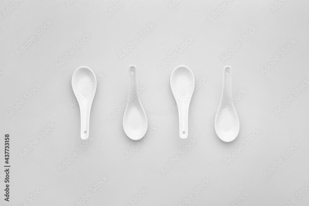 Clean spoons on grey background