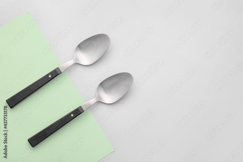 Clean spoons on grey background