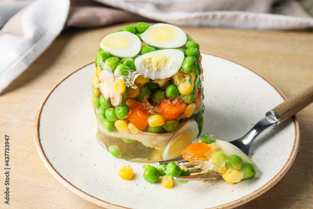 Plate with tasty aspic on table