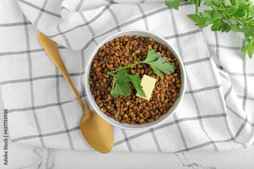 Bowl of tasty cooked lentils on table