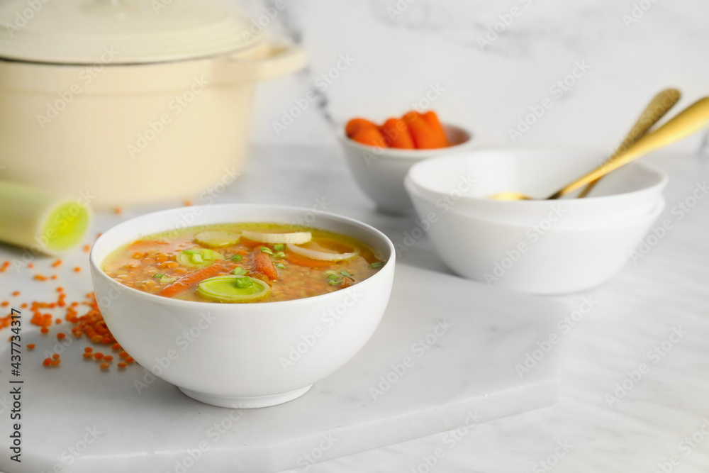 Bowl of tasty lentil soup on table