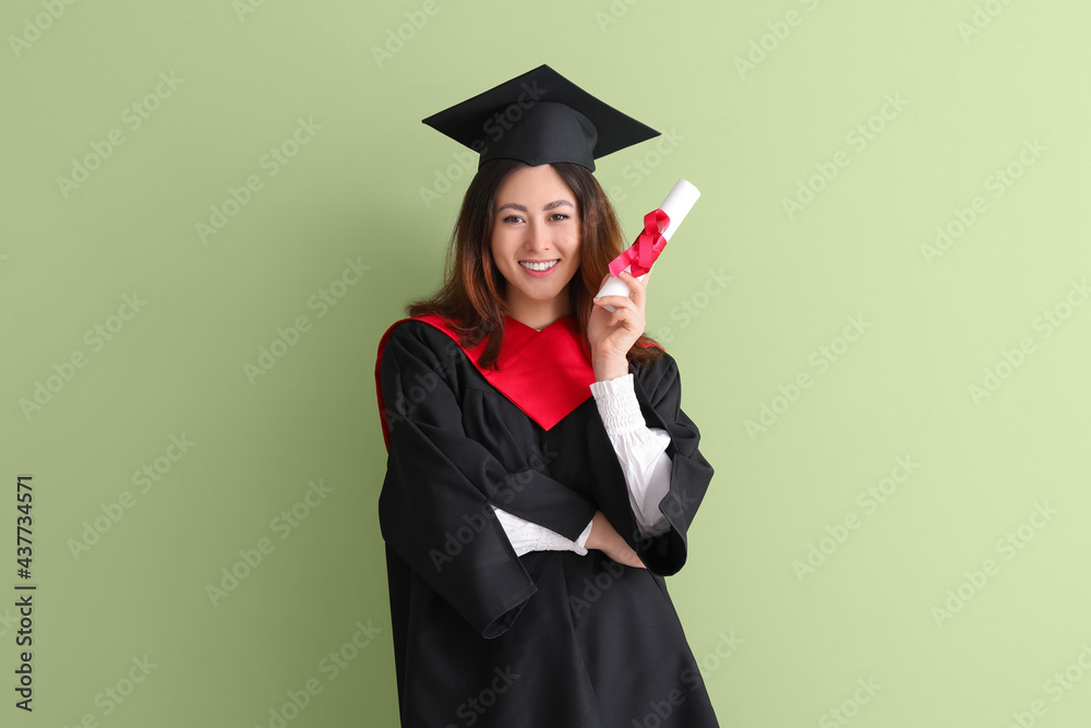 Female graduating student with diploma on color background