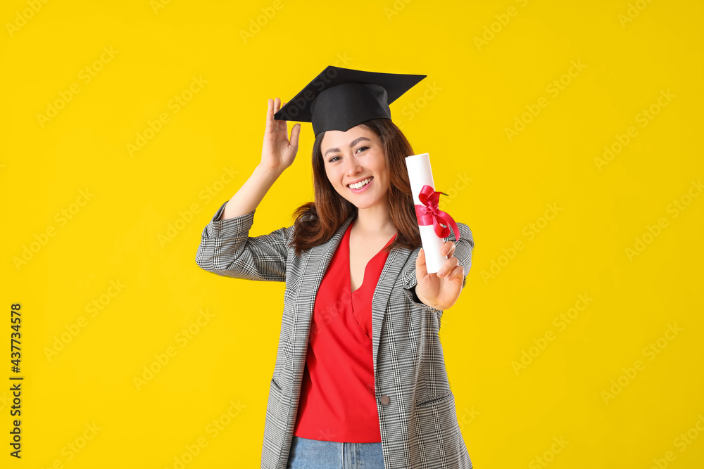 Female graduating student with diploma on color background