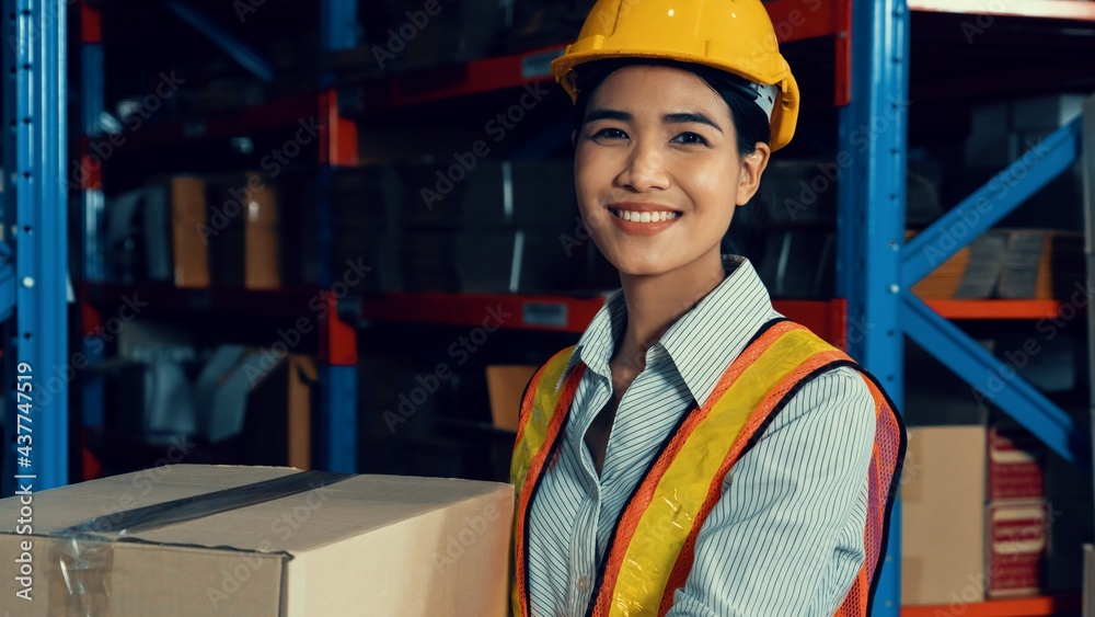 Portrait of young Asian woman warehouse worker smiling in the storehouse . Logistics , supply chain 