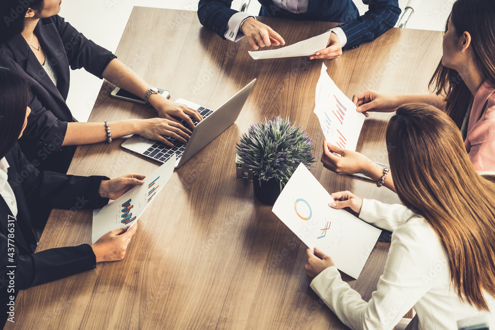 Businesswoman in group meeting discussion with other businesswomen colleagues in modern workplace of