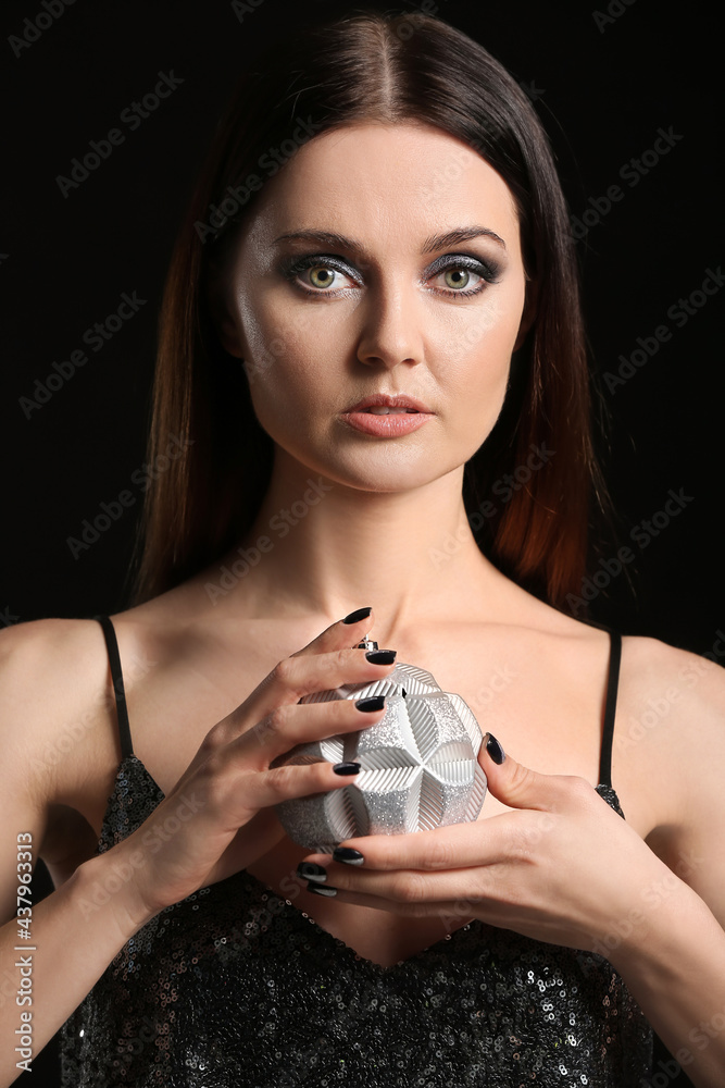 Young woman with beautiful manicure on dark background