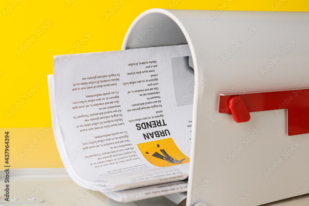 Mail box with newspapers on color background, closeup