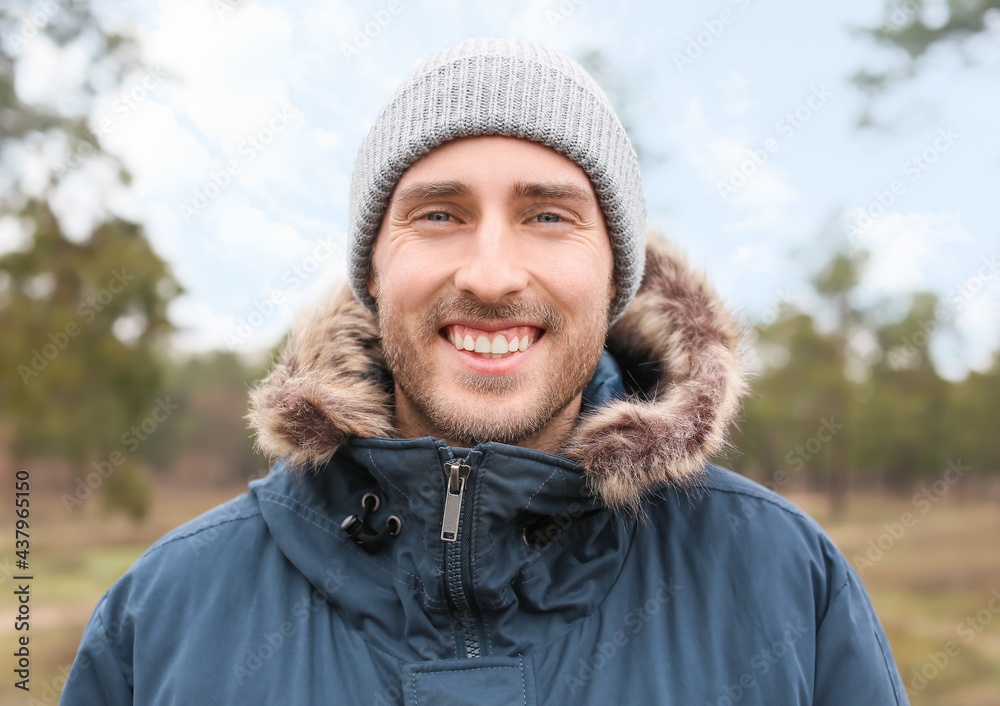 Smiling young man in park