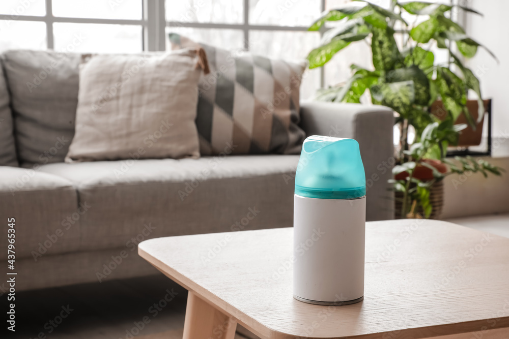 Bottle of air freshener on table in living room