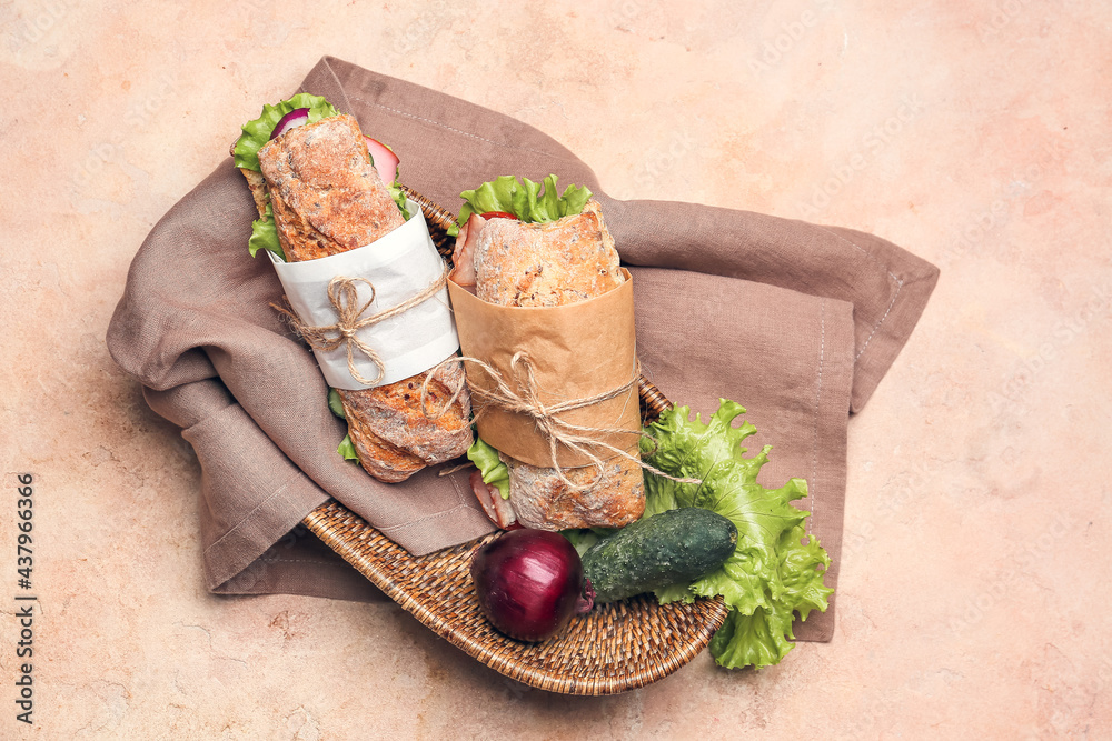 Tasty ciabatta sandwiches on color background