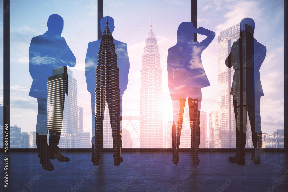 Teamwork concept with men and woman silhouettes on high floor looking through huge window on city sk