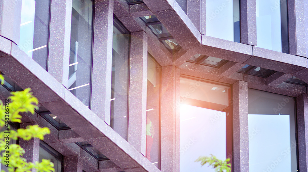 Abstract image of looking up at modern glass and concrete building. Architectural exterior detail of