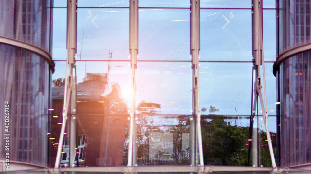 Fragment of the facade.  Facade texture of a glass mirrored office building. Light at sunrise with l