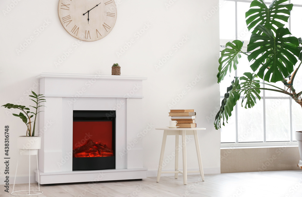 Stylish fireplace in interior of living room