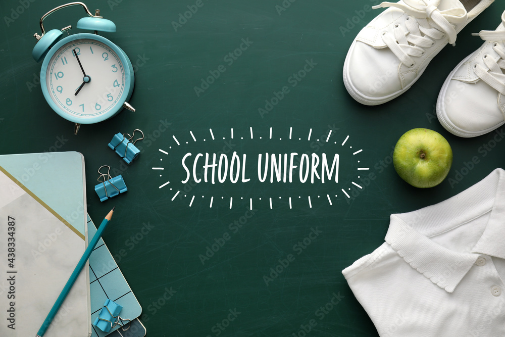 Stylish school uniform with stationery and alarm clock on color background