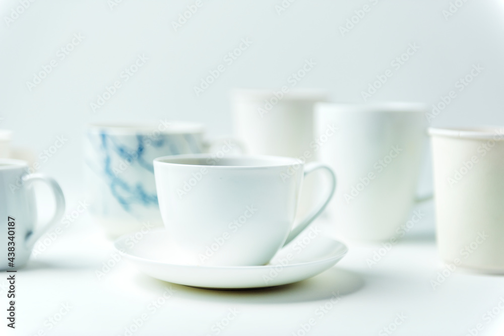 Closeup of coffee cups on white table