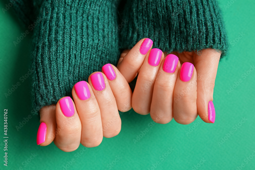 Woman with beautiful manicure on color background