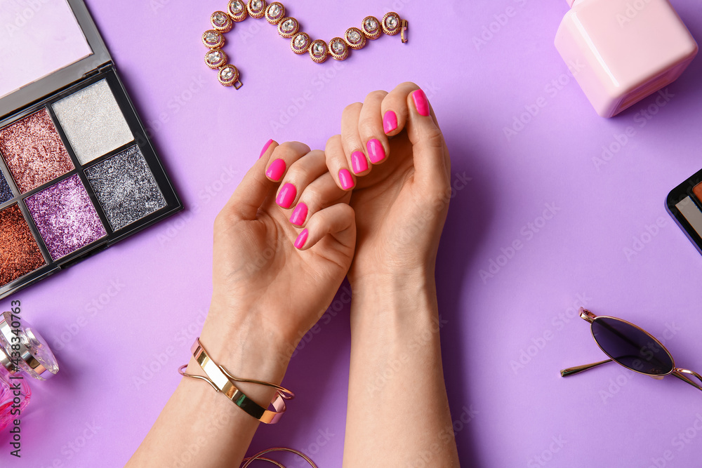 Woman with beautiful manicure and accessories on color background